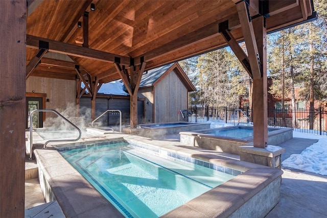 view of pool with a fenced backyard, a patio, a fenced in pool, and an in ground hot tub