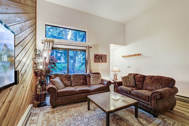 300 Primrose Path Unit 37, Breckenridge, CO 80424 - living room featuring wood finished floors, a baseboard radiator, and a high ceiling