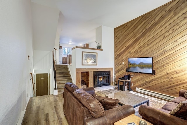 300 Primrose Path Unit 37, Breckenridge, CO 80424 - living area with wooden walls, wood finished floors, a baseboard heating unit, stairway, and a fireplace