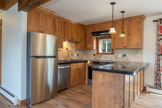602 Ryan Gulch Rd Unit B, Silverthorne, CO 80498 - kitchen with stainless steel appliances, a baseboard heating unit, dark countertops, a peninsula, and light wood-style floors