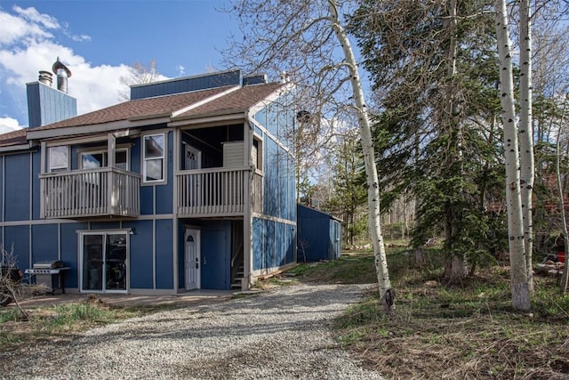 602 Ryan Gulch Rd Unit B, Silverthorne, CO 80498 - rear view of house featuring a chimney and roof with shingles