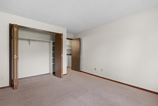 18 Balsam Ct Unit 0, Steamboat Springs, CO 80487 - unfurnished bedroom with light colored carpet, washer / dryer, baseboards, a textured ceiling, and a closet