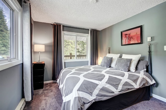 73 Illinois Gulch Rd Unit 8, Breckenridge, CO 80424 - bedroom with dark colored carpet, a textured ceiling, and baseboard heating