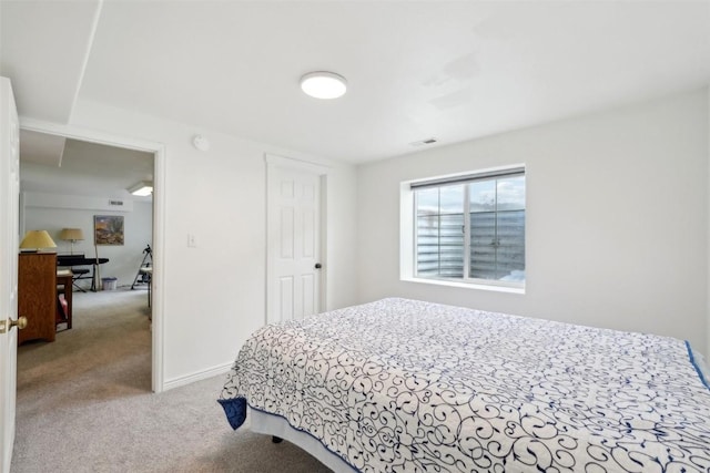 bedroom featuring baseboards, visible vents, and carpet
