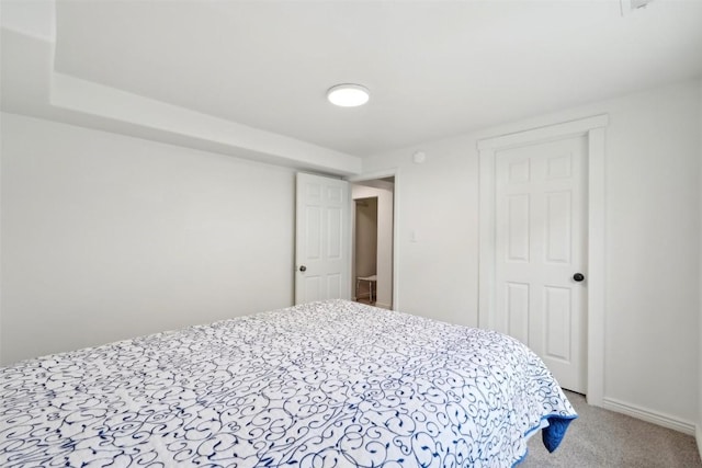 carpeted bedroom featuring baseboards