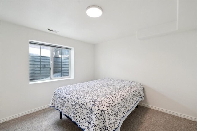 carpeted bedroom with baseboards and visible vents