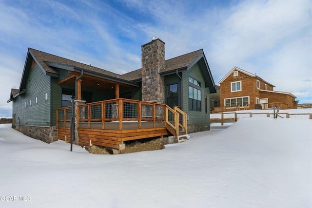 snow covered house with a chimney