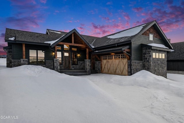 view of front of property with stone siding and a garage