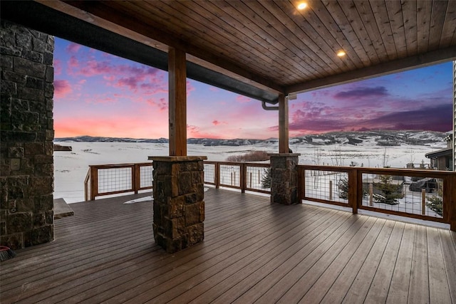 snow covered deck featuring a mountain view