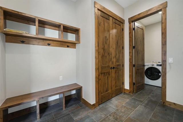 mudroom featuring washer / dryer, stone finish floor, and baseboards