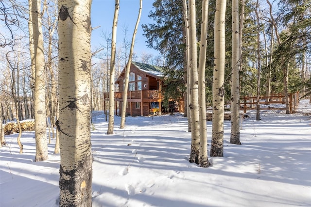snowy yard featuring a deck