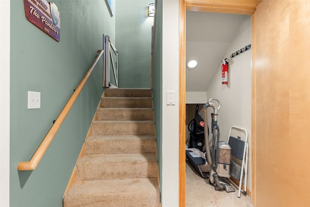 stairs featuring vaulted ceiling