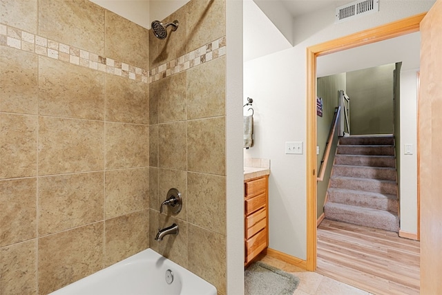 full bathroom featuring baseboards, visible vents, vanity, and bathing tub / shower combination