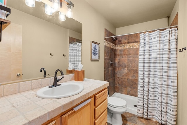 full bathroom featuring toilet, vanity, and tiled shower