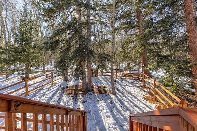 yard layered in snow with fence