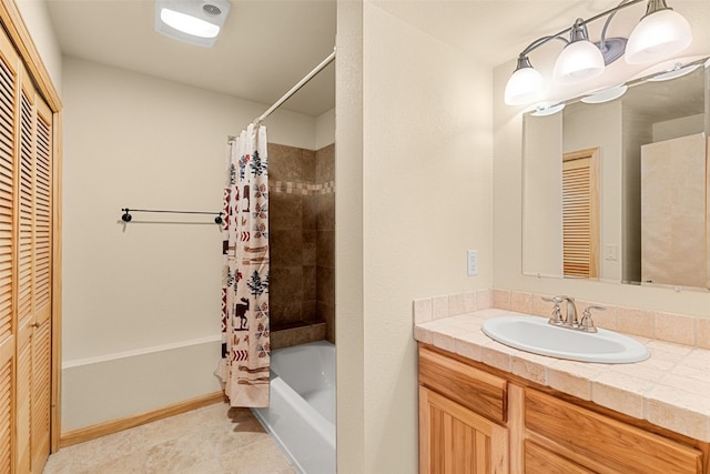 bathroom with shower / tub combo, vanity, and a closet