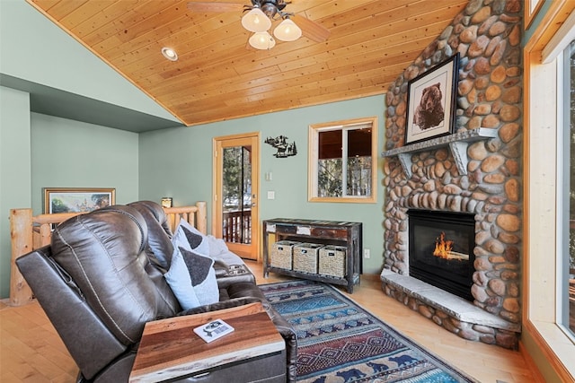 living room with lofted ceiling, a ceiling fan, wood ceiling, and wood finished floors