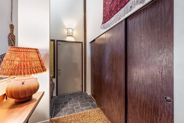 doorway featuring stone finish floor