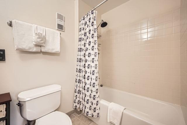 755 Columbine Rd Unit 303, Breckenridge, CO 80424 - full bath featuring toilet, shower / bath combo with shower curtain, and tile patterned floors