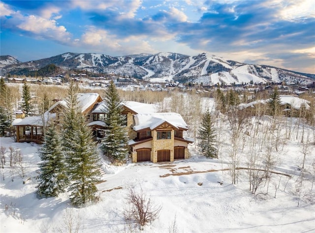 snowy aerial view with a mountain view