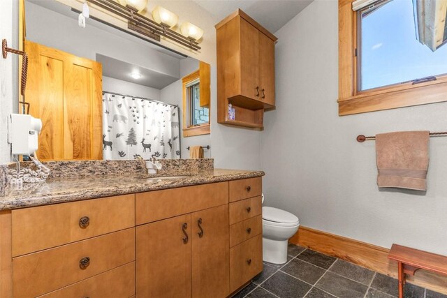 full bath with curtained shower, toilet, vanity, baseboards, and tile patterned floors