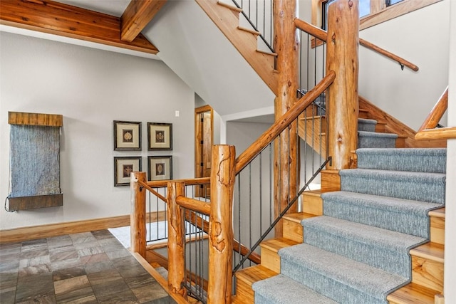 stairs with beamed ceiling and baseboards