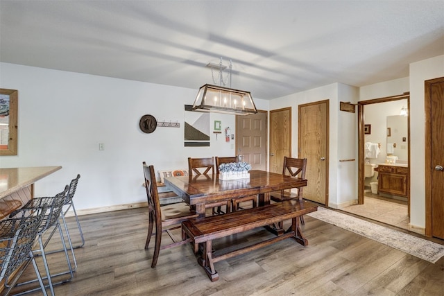 23034 US Highway 6 Unit 203, Dillon, CO 80435 - dining space with light wood-style flooring and baseboards