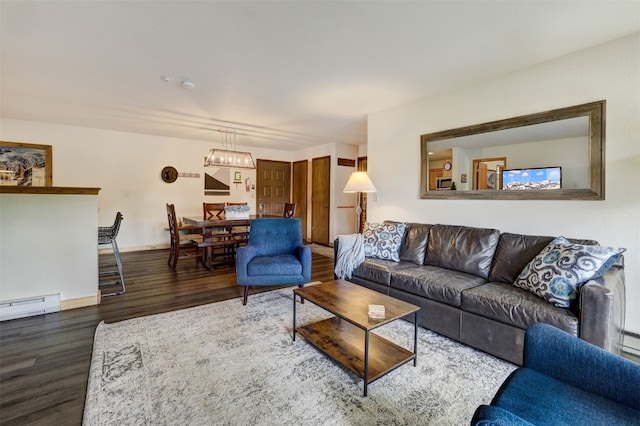 23034 US Highway 6 Unit 203, Dillon, CO 80435 - living area with wood finished floors, baseboards, and a baseboard heating unit