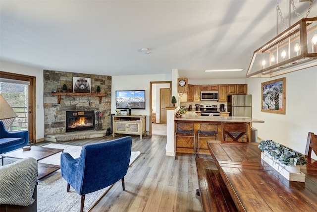23034 US Highway 6 Unit 203, Dillon, CO 80435 - living room featuring light wood finished floors and a fireplace