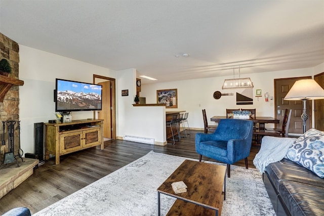 23034 US Highway 6 Unit 203, Dillon, CO 80435 - living room featuring a baseboard heating unit, wood finished floors, and baseboards