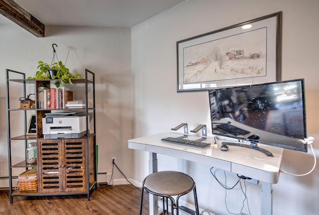 office with a baseboard heating unit, baseboards, and wood finished floors