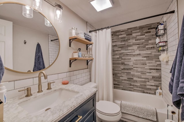 2442 Ryan Gulch Ct Unit 204, Silverthorne, CO 80498 - bathroom with toilet, shower / tub combo, vanity, backsplash, and tile walls