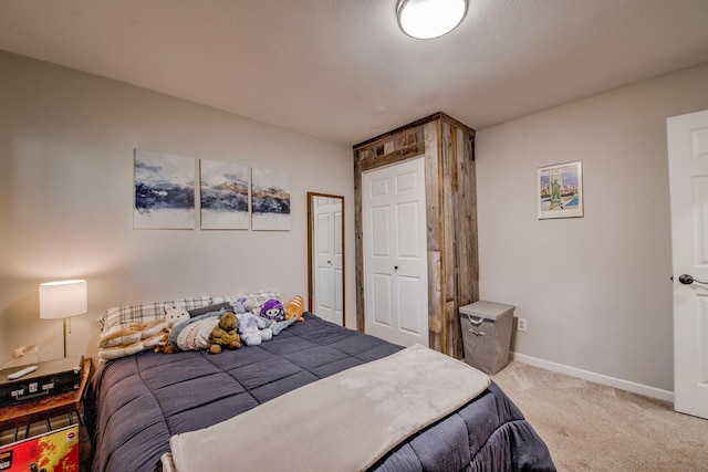 carpeted bedroom with baseboards