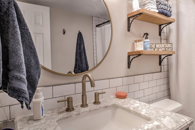 bathroom featuring backsplash, tile walls, and vanity