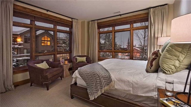 carpeted bedroom featuring visible vents