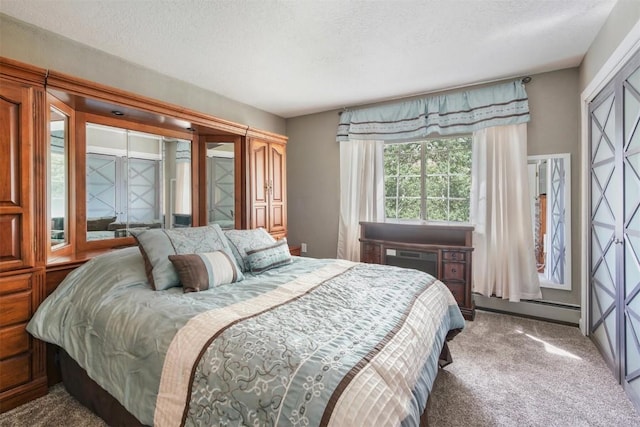 897 Deer Path Rd, Dillon, CO 80435 - bedroom featuring baseboard heating, a textured ceiling, carpet floors, and an AC wall unit