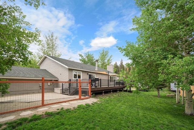 897 Deer Path Rd, Dillon, CO 80435 - back of property featuring a deck, a yard, a chimney, and a patio