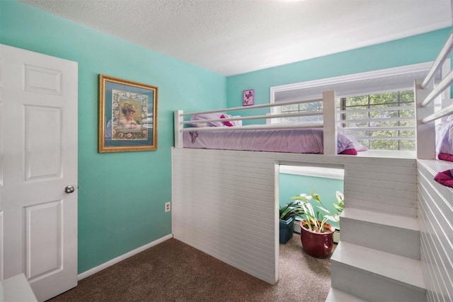 897 Deer Path Rd, Dillon, CO 80435 - carpeted bedroom featuring a textured ceiling and baseboards