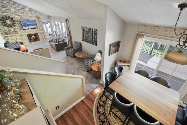 897 Deer Path Rd, Dillon, CO 80435 - dining room with healthy amount of natural light, lofted ceiling, a fireplace, and wood finished floors