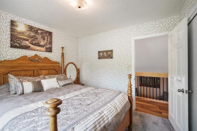 897 Deer Path Rd, Dillon, CO 80435 - bedroom with a textured ceiling, carpet floors, and wallpapered walls