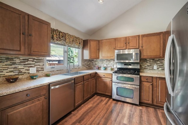 897 Deer Path Rd, Dillon, CO 80435 - kitchen featuring appliances with stainless steel finishes, a sink, lofted ceiling, backsplash, and dark wood-type flooring