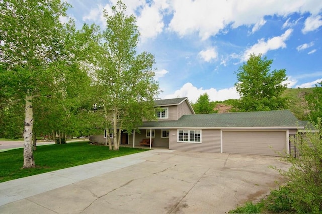 897 Deer Path Rd, Dillon, CO 80435 - traditional-style home featuring a garage, concrete driveway, a front yard, and a porch