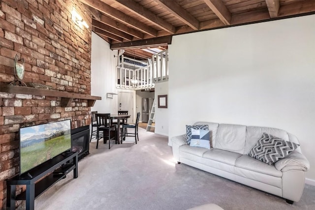 2200 Lodgepole Cir Unit 308, Silverthorne, CO 80498 - living area with wood ceiling, a brick fireplace, beam ceiling, carpet floors, and baseboards