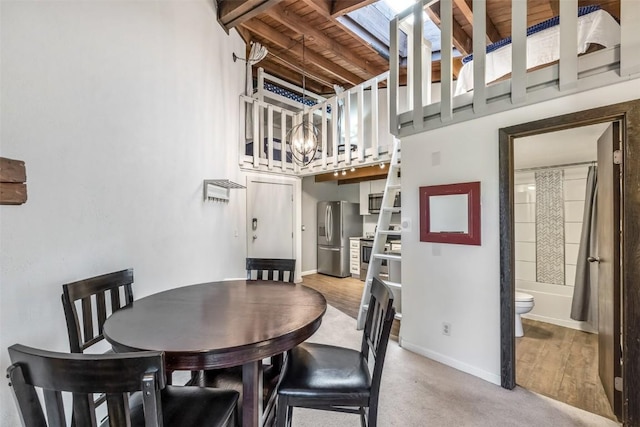 2200 Lodgepole Cir Unit 308, Silverthorne, CO 80498 - dining area with baseboards, a high ceiling, and a chandelier