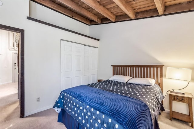 2200 Lodgepole Cir Unit 308, Silverthorne, CO 80498 - bedroom with wood ceiling, baseboards, beamed ceiling, a closet, and carpet flooring