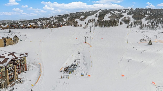 snowy aerial view with a mountain view