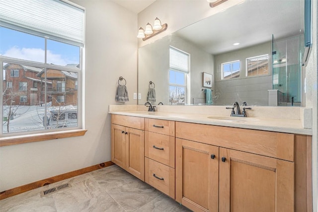 bathroom featuring vanity and a shower