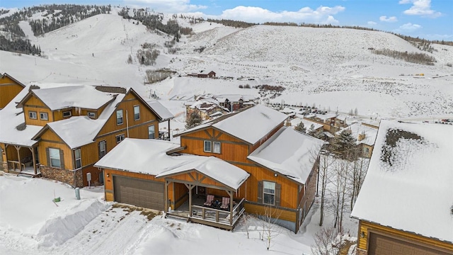 snowy aerial view featuring a mountain view