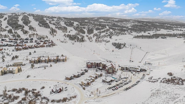 snowy aerial view featuring a mountain view