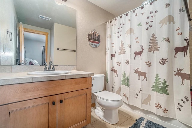 full bathroom with vanity, tile patterned floors, toilet, and shower / bath combo with shower curtain